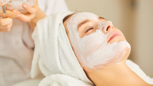 Woman enjoying a relaxing BlushByEve facial treatment.